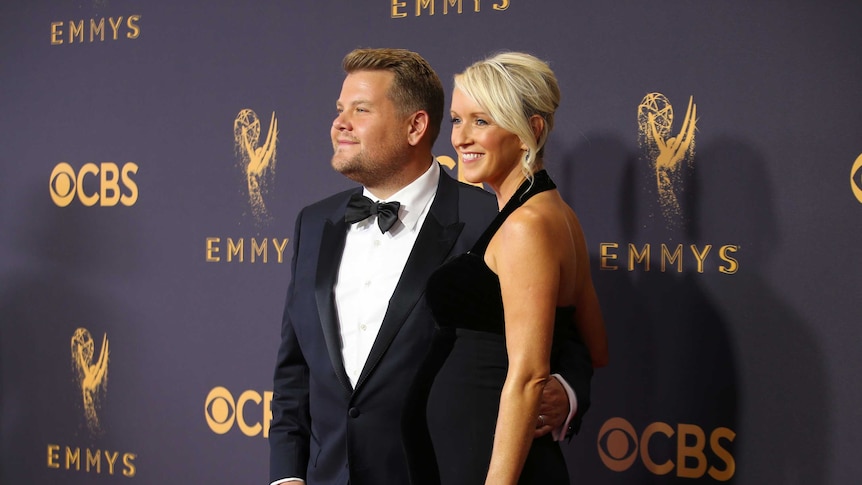 Actor and television host James Corden and his wife Julia Carey both wearing black.