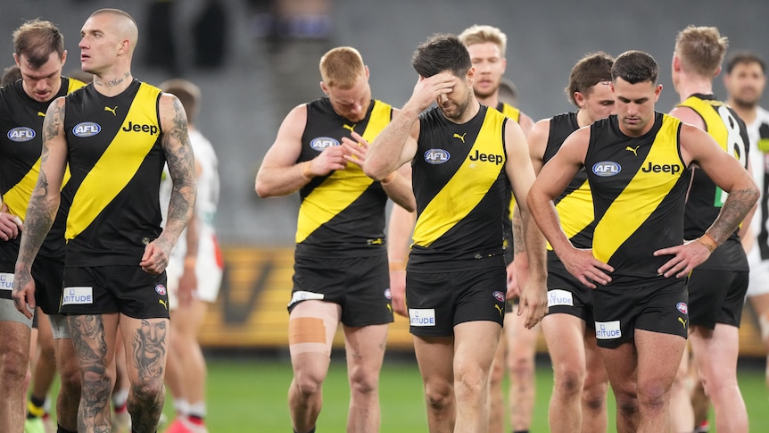 A group of Richmond AFL players walk off the MCG after losing to St Kilda.