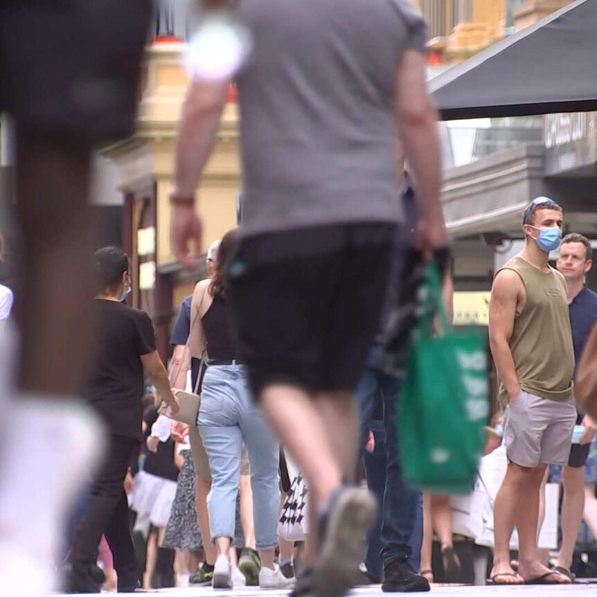 People walking with shopping bags in Adelaide.