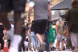People walking with shopping bags in Adelaide.