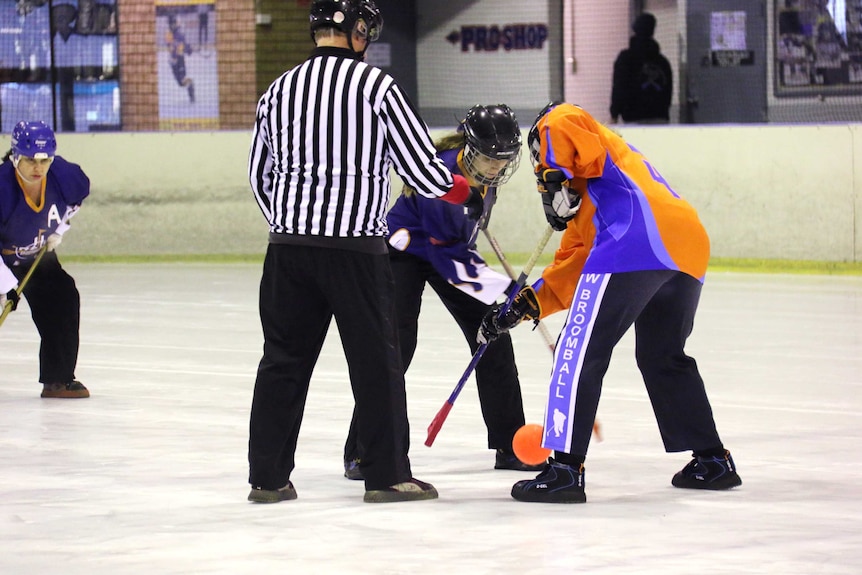 ACT play New South Wales in broomball on an ice rink.