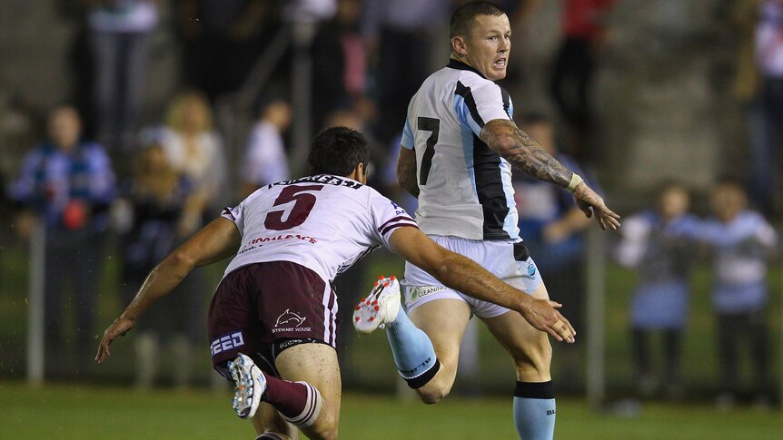 Todd Carney makes a break in an NRL trial match