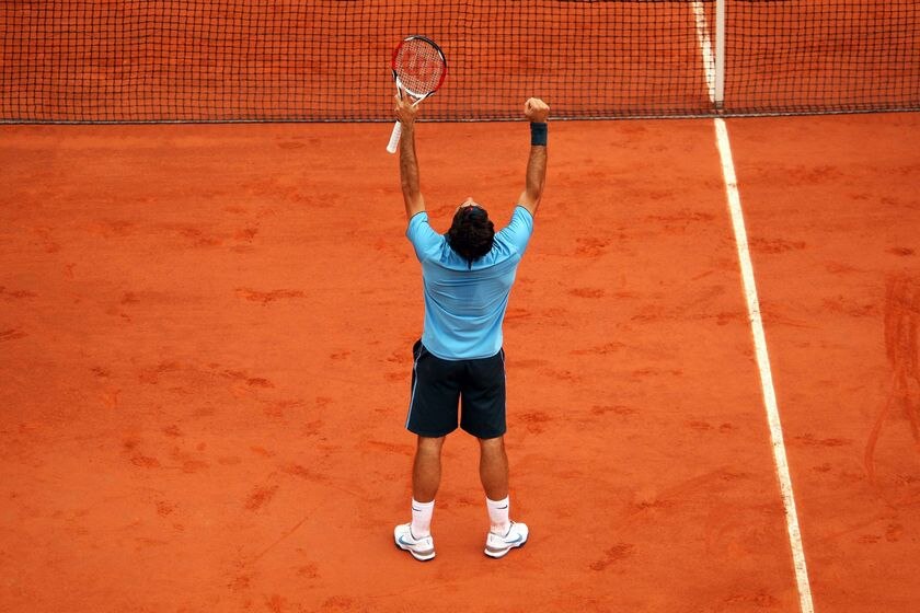 Roger Federer celebrates winning the French Open