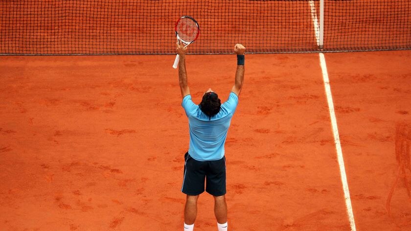 Roger Federer celebrates winning the French Open