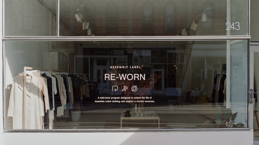 a shop front with clothing in window and the sign 'reworn'