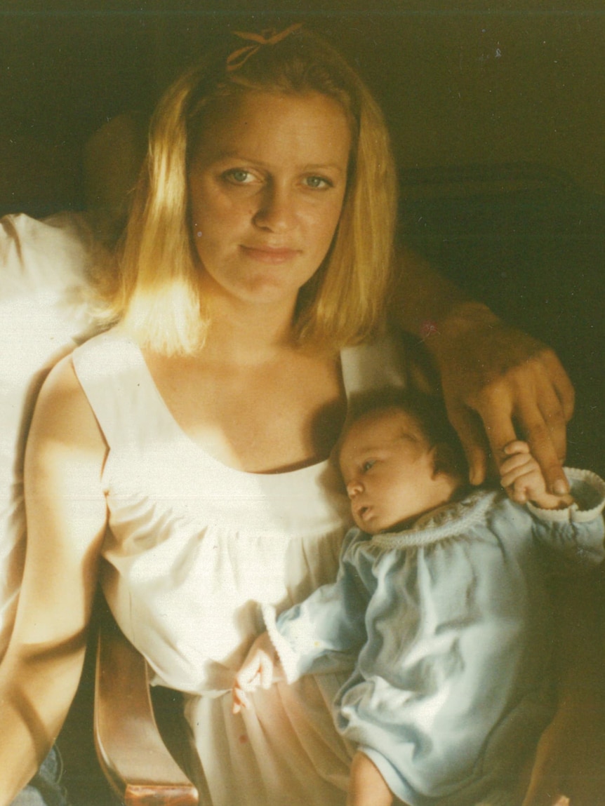 Elizabeth Henry holds a baby.