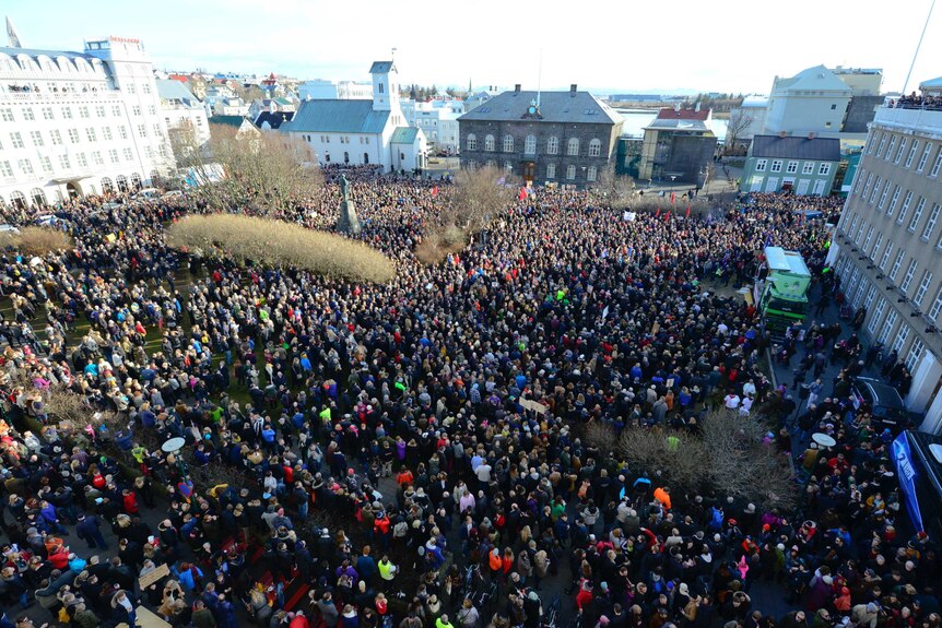 Elevated view of a large crowd of people demonstrating in a square in Reykjavik, Iceland.