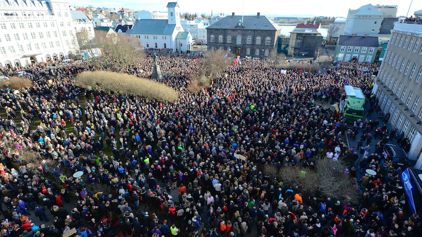 Elevated view of a large crowd of people demonstrating in a square in Reykjavik, Iceland.
