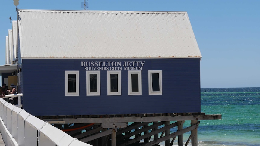 A tourist shop sits out on the water at a jetty