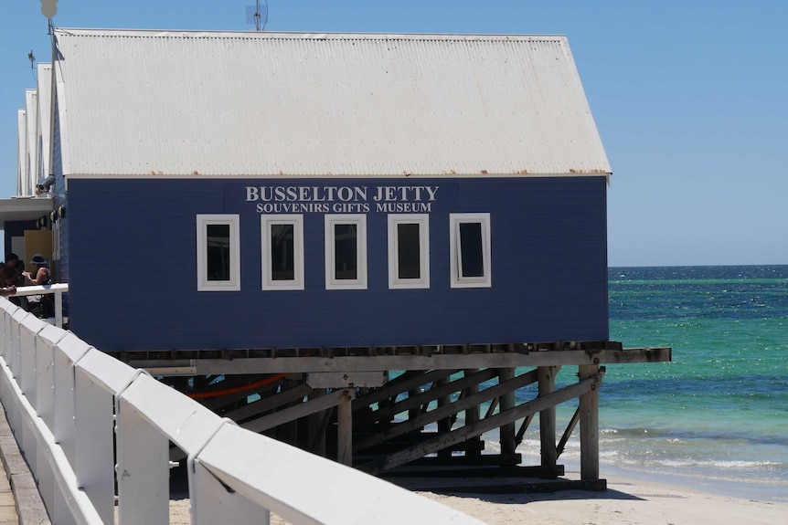 A tourist shop sits out on the water at a jetty