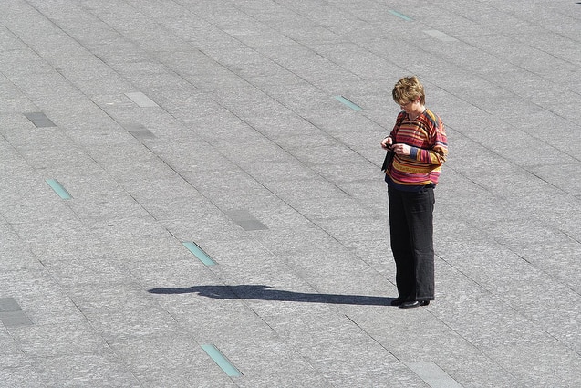 A photo taken in the square in 2010 of a woman standing in the sun.