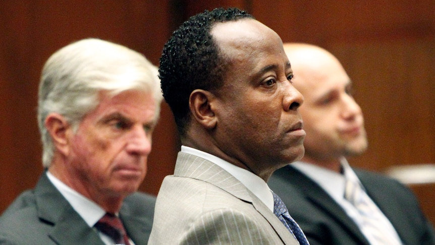 On trial: defence attorneys sit beside Conrad Murray