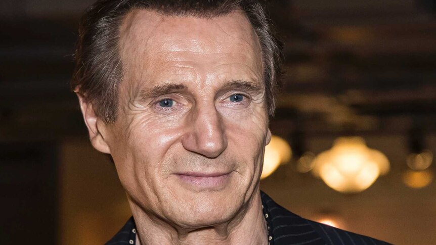 actor Liam Neeson poses for photographers