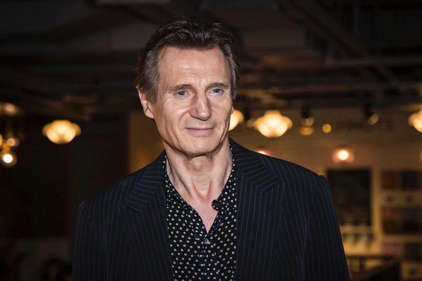 actor Liam Neeson poses for photographers