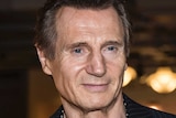 actor Liam Neeson poses for photographers