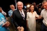 Colin Barnett is greeted by supporters while walking with his wife Lyn.