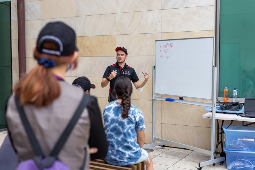 Dr Cook explaining the physics of radio astronomy to students at the Stargirls STEM camp.