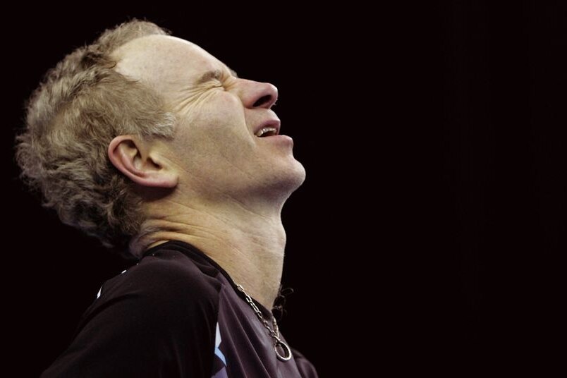 John McEnroe reacts as a line call goes against him