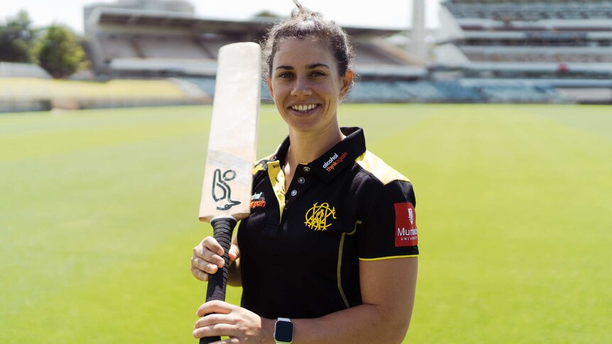 WA cricketer Nicole Bolton holds up a cricket bat at the WACA.