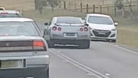 A car driving on the wrong side of the road.