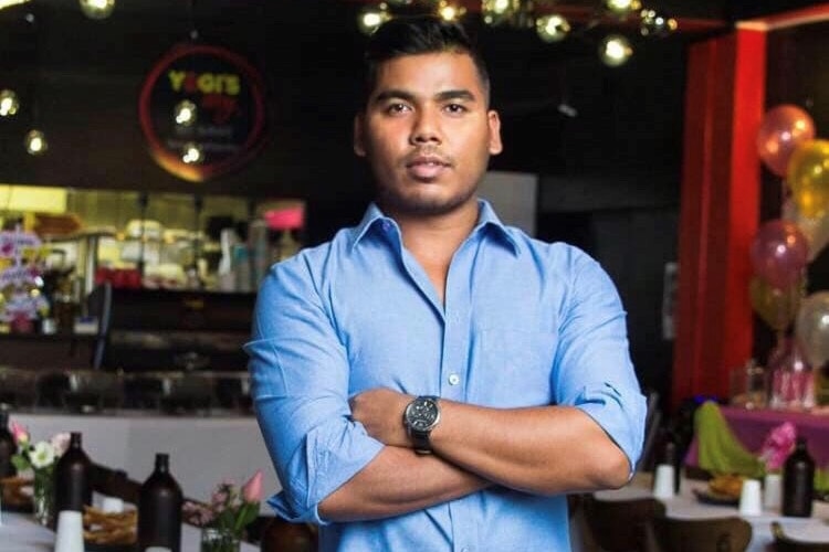 Stuart Park restaurant Yogi's Way owner Bhairab Yogi standing in the restaurant blue shirt arms folded