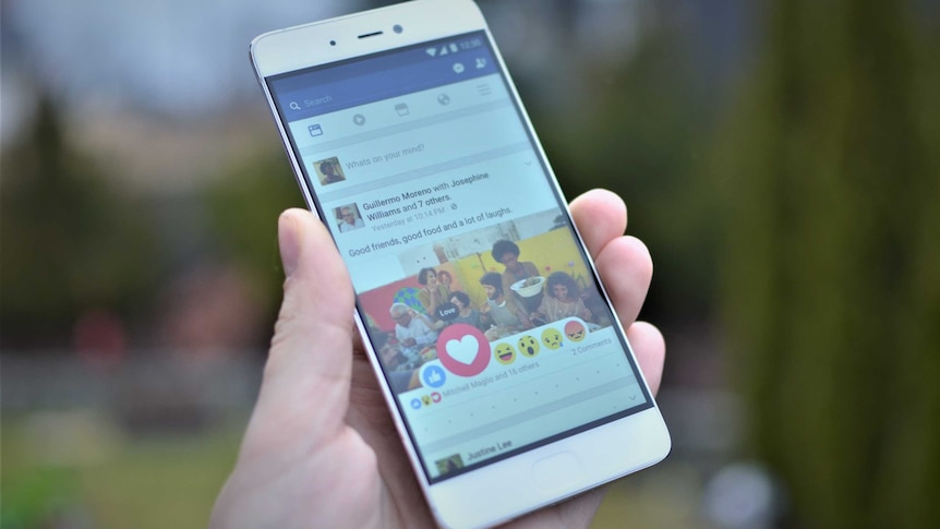 A smartphone shows a Facebook feed and the available reactions.