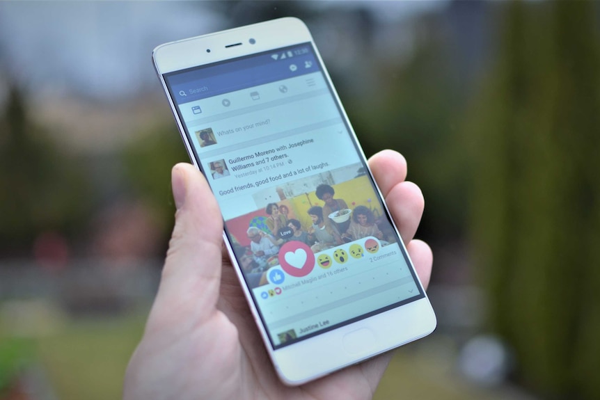 A smartphone shows a Facebook feed and the available reactions.