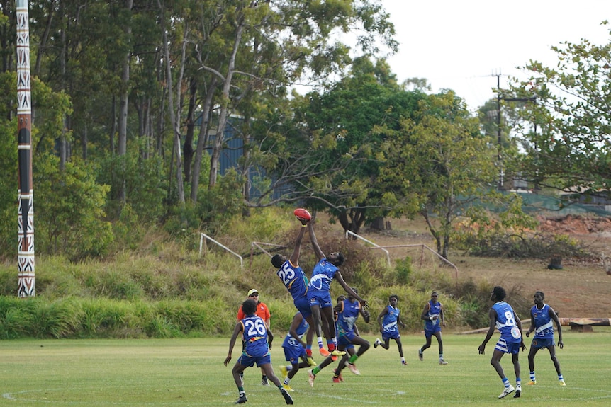 Two players contest the ball up in the air.