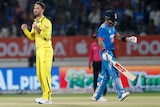 Glenn Maxwell celebrates as Virat Kohli walks away.