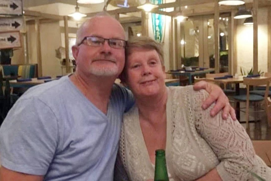 Mick Duke and his wife Jo'Anne sitting down in an eating area, he has his arm around her. She died after a car crash in 2019