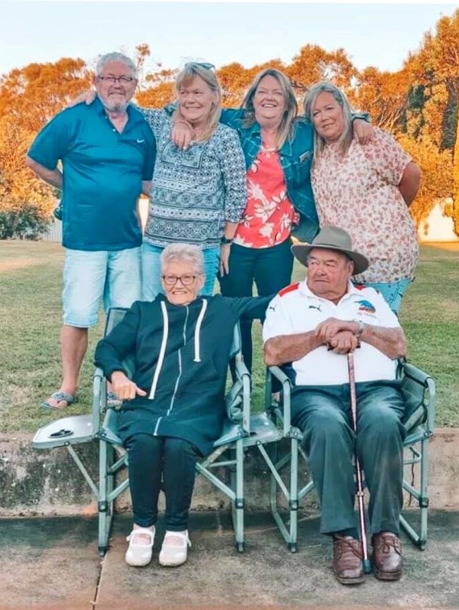 Nan and Ned Walker sit in front of four members of the family