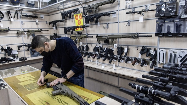 A man stands in a gun shop