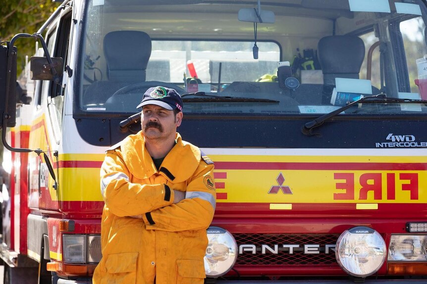 A rural firefighter leans on a fire truck at the Peregian Springs Control.