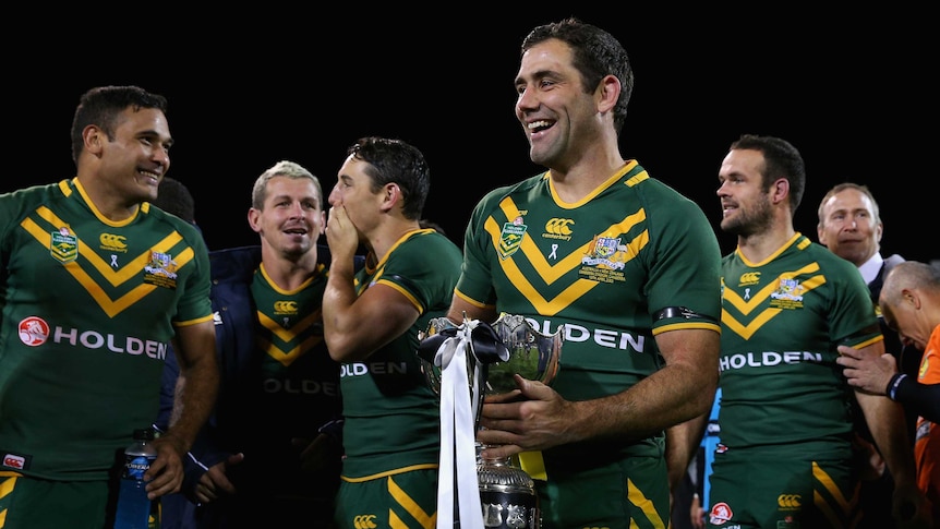 Time to celebrate ... Kangaroos captain Cameron Smith and team-mates enjoy a walk with the trophy.