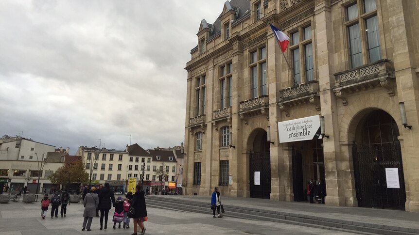 People standing outside the Saint Denis Town Hall.