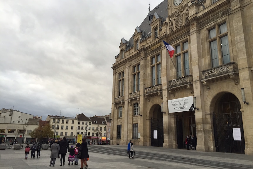 People standing outside the Saint Denis Town Hall.