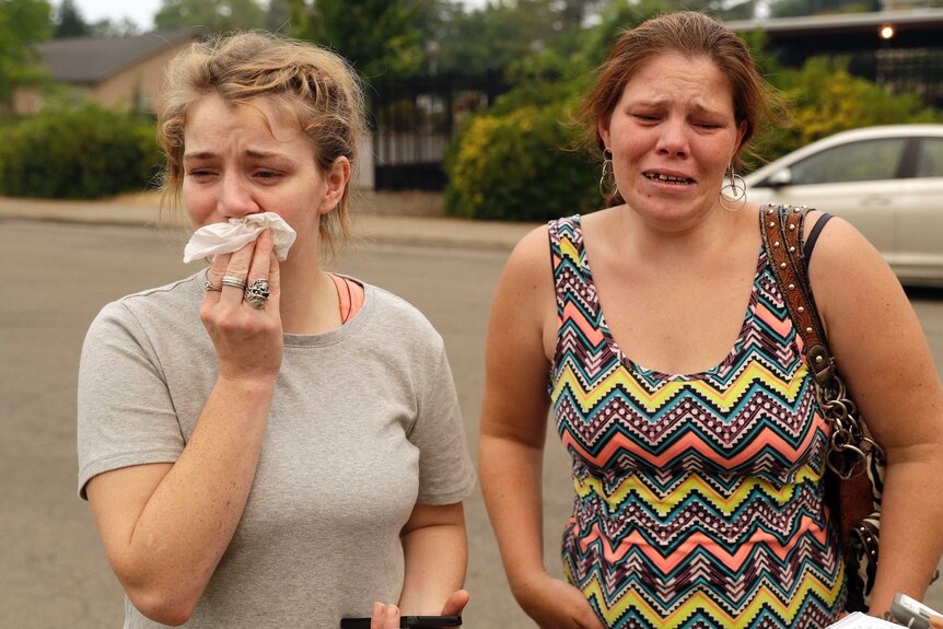 Sherry Bledsoe, left, cries next to her sister, Carla, outside of the sheriff's office