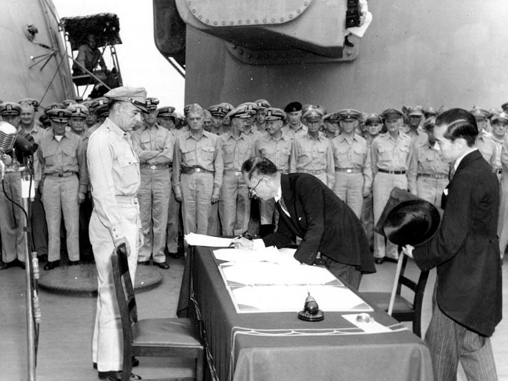 Japanese foreign affairs minister Mamoru Shigemitsu signs the Japanese Instrument of Surrender
