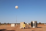 A hydrogen weather balloon is released at the Giles Weather Station.