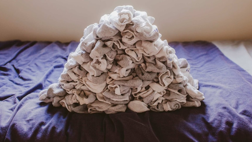 A pile of socks on a bed