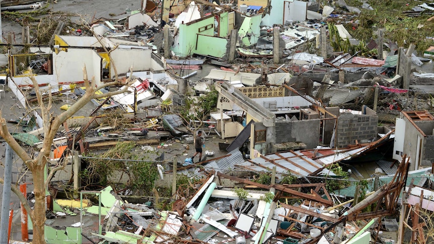 Man walks among destroyed houses in Philippines