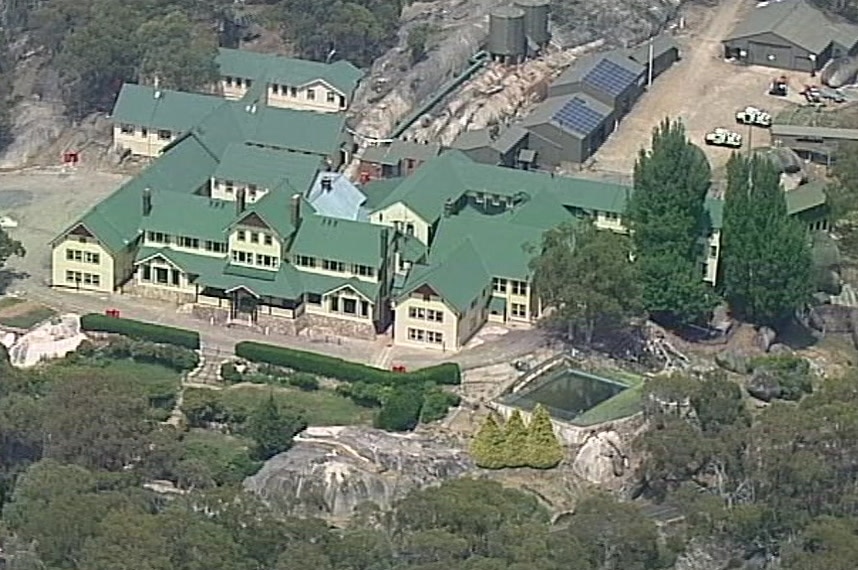 An aerial photo of the Mount Buffalo Chalet showing an older-style building with extensions and green roofing.