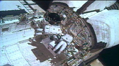 Astronauts prepare for a third space walk to fix the space shuttle Discovery.