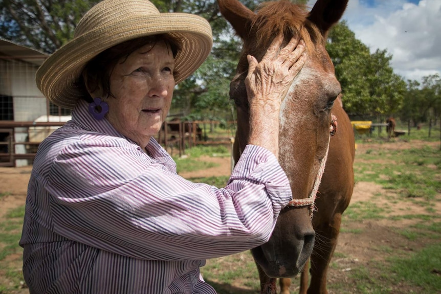 Pauline pats a horse