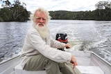 Bruce Pascoe at the helm of a small boat on the Wallagaraugh River