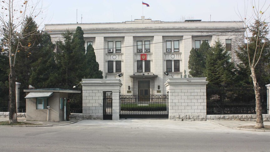 A gated Russian embassy in Pyongyang guarded by security