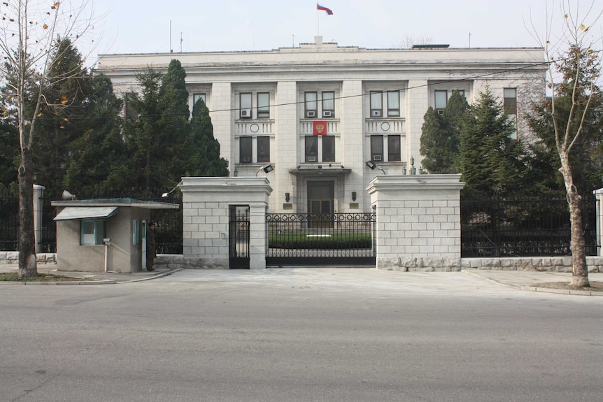 A gated Russian embassy in Pyongyang guarded by security