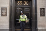 Police officer leaves safe deposit building in London