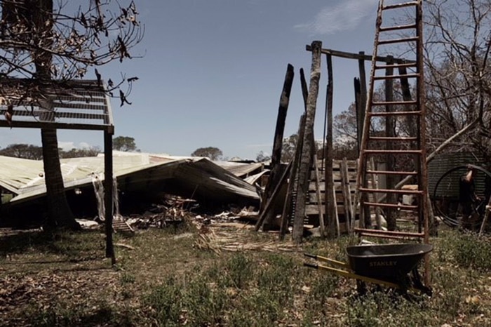 Damaged equipment and shed after a bushfire at apiarist George Spiteri's property at Deepwater.