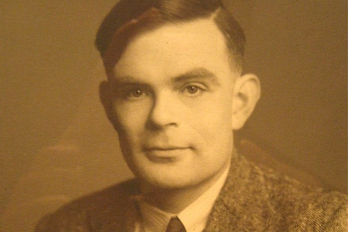 A sepia portrait photograph of Alan Turing.